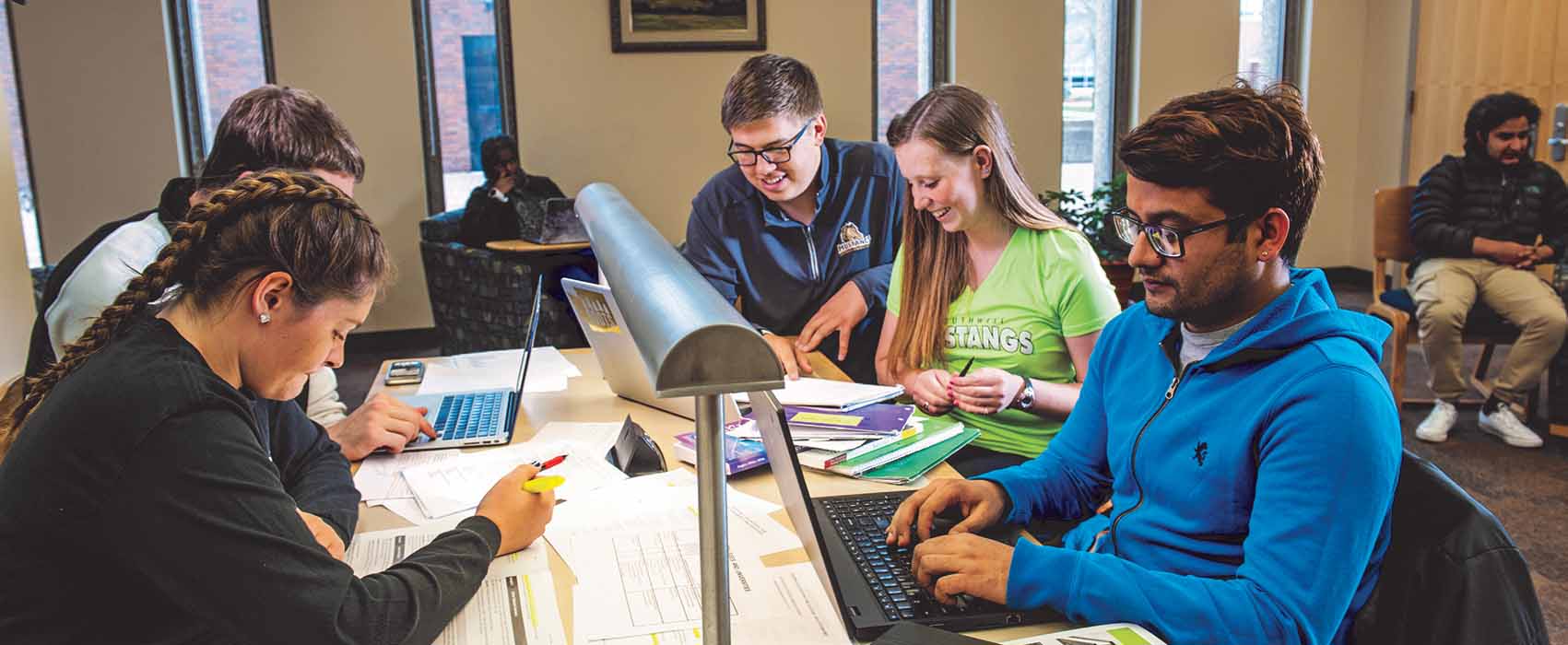 Students working on computers in campus commons area