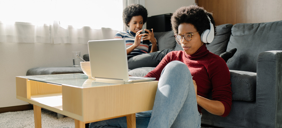 Students using tech in living room