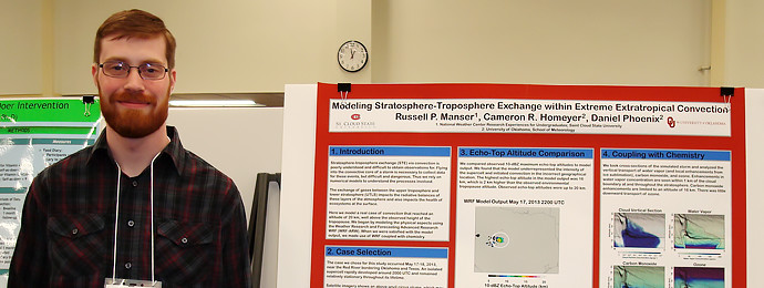 Minnesota State undergraduate student with scholarly research poster