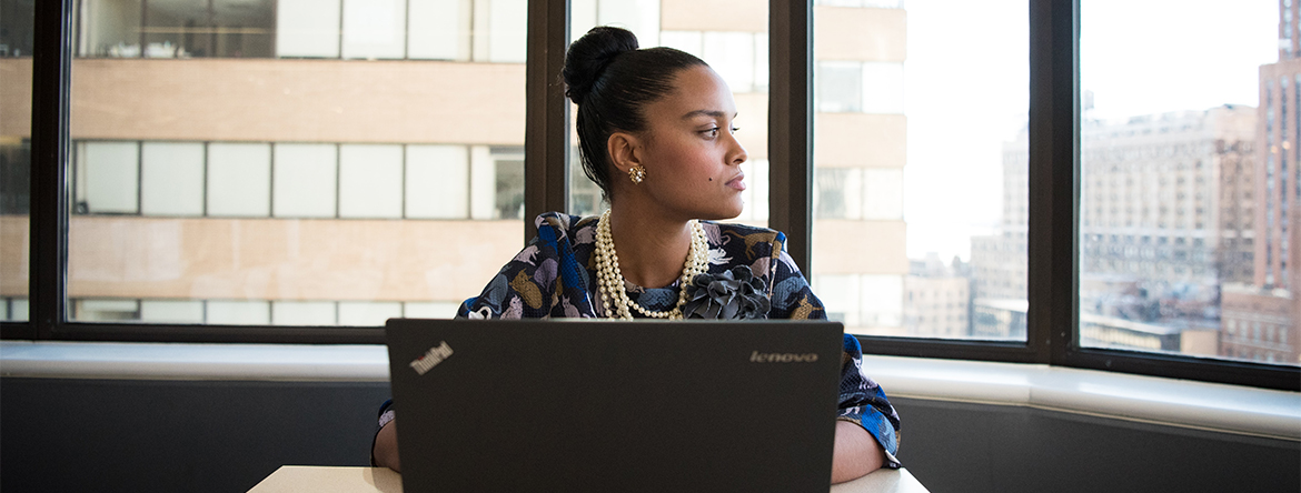 African American woman sitting in front of a laptop
