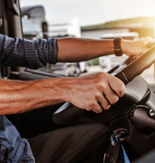man driving truck - focus on steering wheel