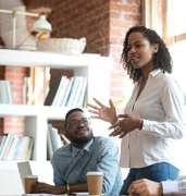 woman standing up and talking in a casual business meeting