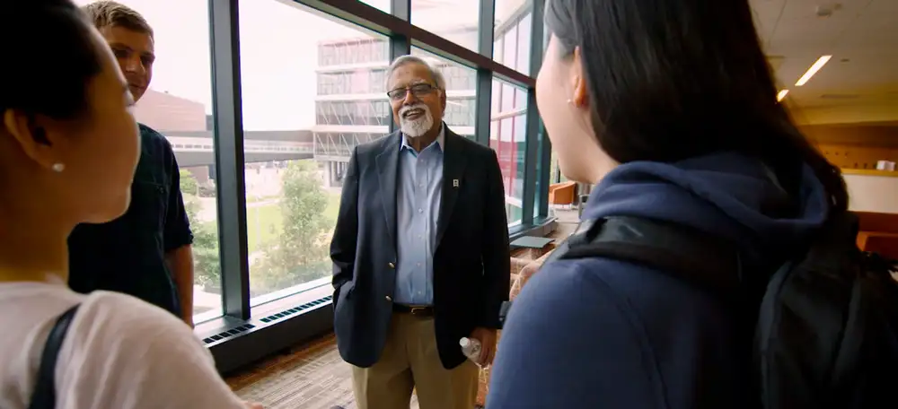 Photo of Chancellor Devinder Mahotra with Minneapolis College students