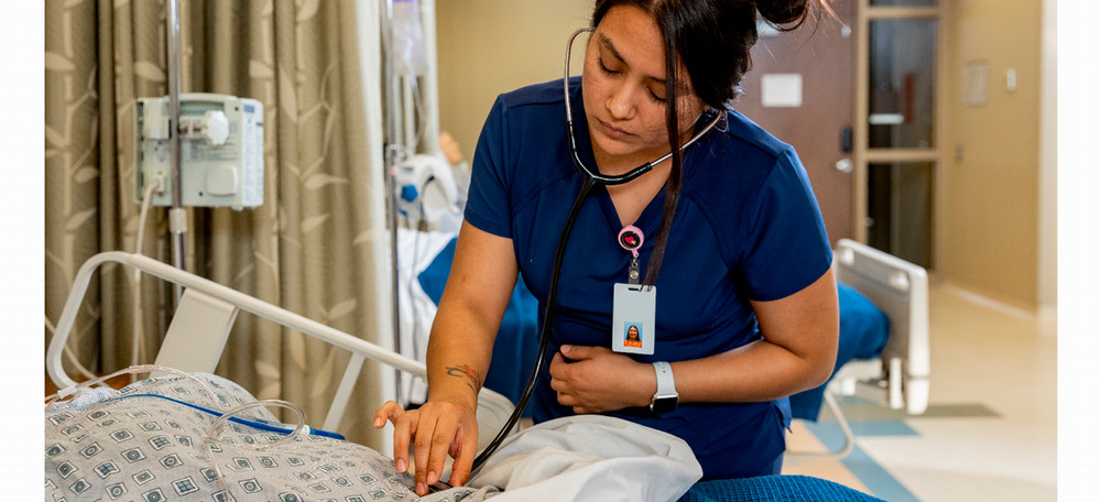 Nurse with patient in nursing lab